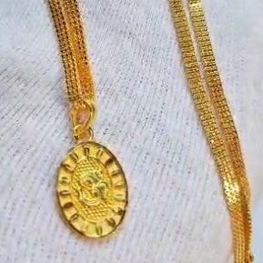 Gold necklace with a pendant on a white background